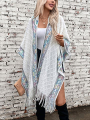 White knit hooded wrap with embroidered trim and fringe detail, acrylic.