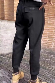 Black cotton sweatpants with drawstring and back pockets.