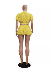 Yellow zip-up crop top and drawstring shorts set with short sleeves.