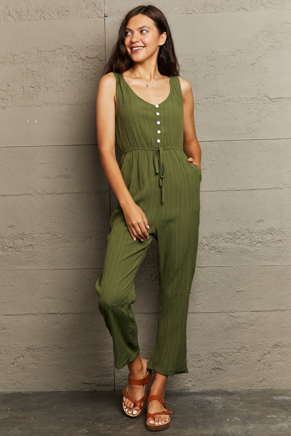 Matcha green linen blend button-down jumpsuit with drawstring waist and wide legs.