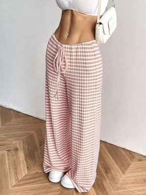 Pink and white striped ribbed wide-leg pants with drawstring waist.