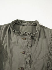 Ruffled denim vest in olive green with button closure and ruffled neckline detail.