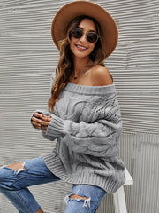 Gray cable knit off-shoulder sweater with open knit details and slouchy fit.