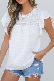 White eyelet yoke ruffle sleeve blouse with lace trim and floral embroidery.