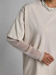 Oversized tee in Camel with sheer, metallic long sleeves layered underneath.