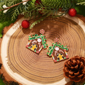 Festive gingerbread house dangle earrings with candy cane and gingerbread man details.