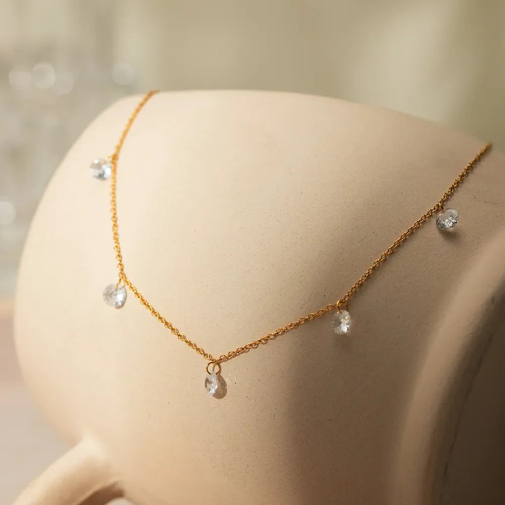 Gold dangling crystal station necklace with delicate chain