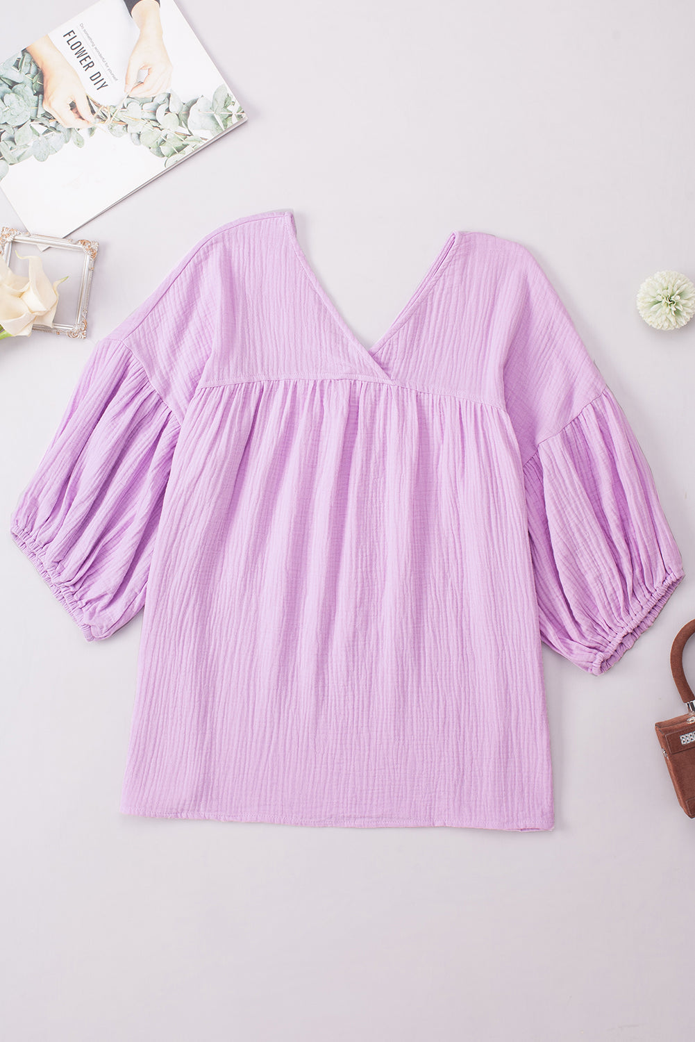 Textured gauze blouse in Heliotrope Purple with V-neck and gathered balloon sleeves.