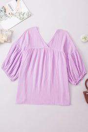 Textured gauze blouse in Heliotrope Purple with V-neck and gathered balloon sleeves.