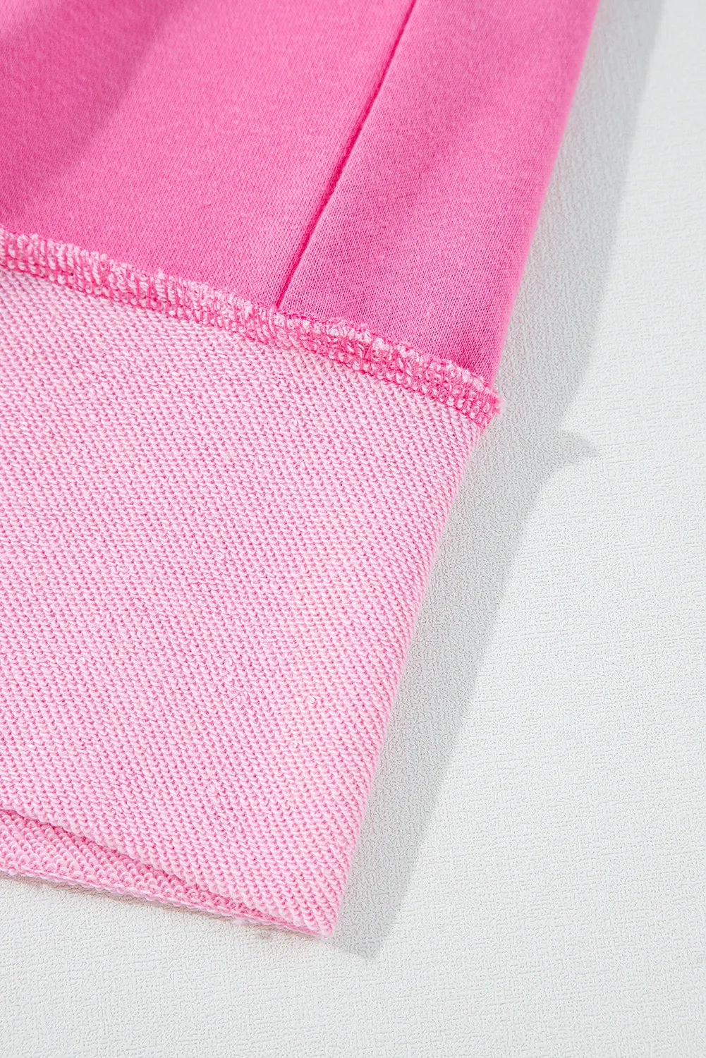 Fuchsia pink cotton loungewear set with contrast trim and raw edge detail.
