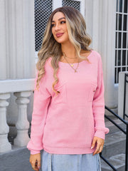 Dusty Pink knit sweater with textured pockets and button details.