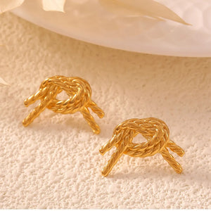 Golden knot stud earrings with a twisted rope design.