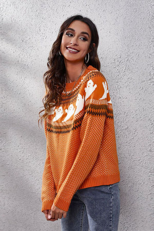 Orange crewneck sweater with jacquard ghost pattern and ribbed cuffs and hem.
