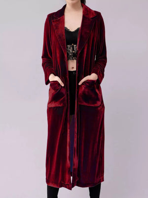 Burgundy velvet longline trench coat with pockets and draped open front.