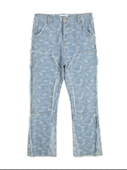 Light blue bootcut jeans with all-over paisley print and distressed panel details.