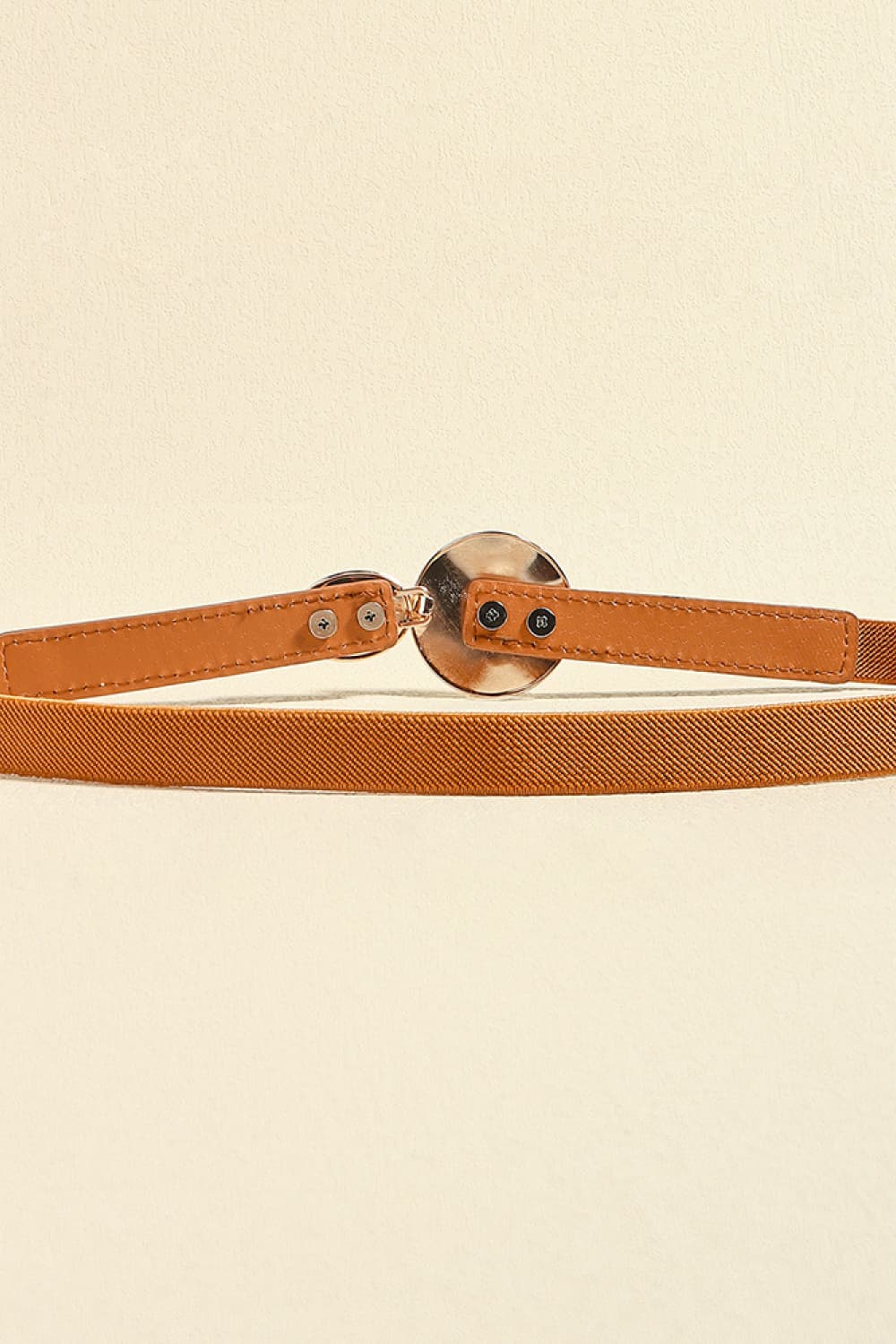 Caramel elastic waist belt with disc detail and faux leather trim