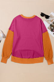 Chic Contrast Crewneck Sweatshirt in magenta and orange with long sleeves and crew neck.