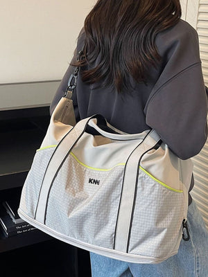 Large gray nylon duffel bag with grid pattern and neon trim, detachable strap.