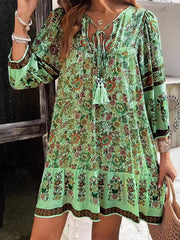Matcha green floral print mini dress with tassel tie neckline and tiered hem