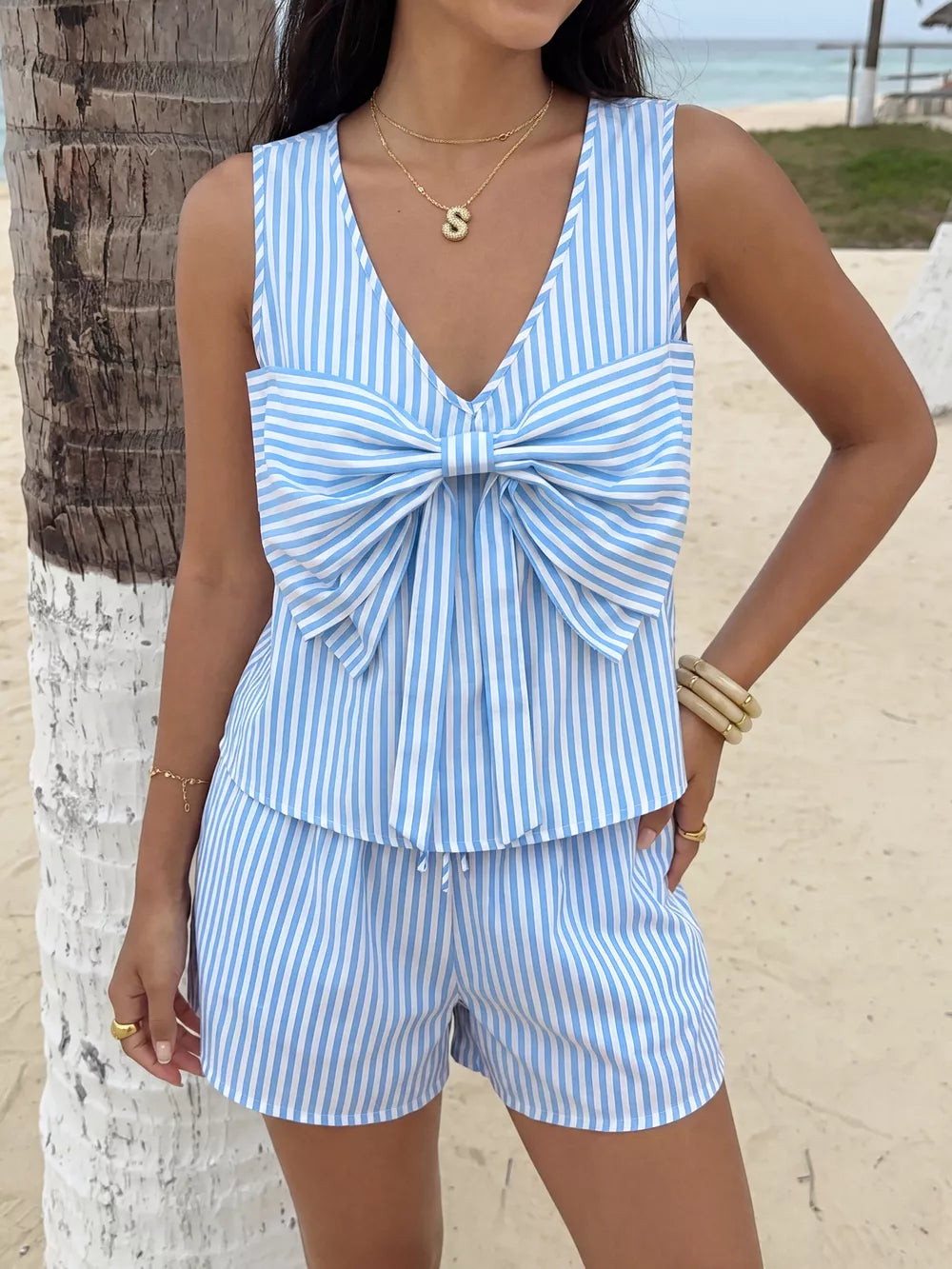 Blue and white striped two-piece set with a large bow detail on the top and drawstring shorts.