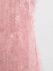 Pink iridescent sequin halter mini dress with mesh overlay and circular sequin details.
