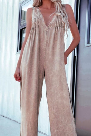 Khaki denim jumpsuit with pleated V-neck bodice and wide legs