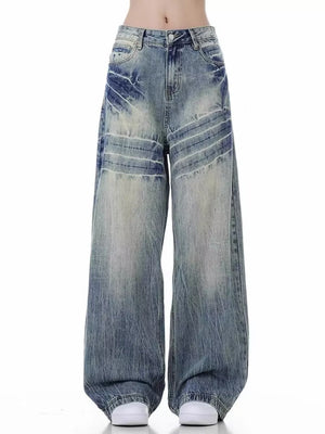 Men's vintage distressed wide-leg jeans in light blue cotton with faded wash and whiskering.