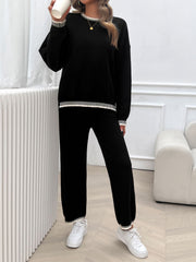 Black knit lounge set with ribbed trim on neckline, cuffs, and hem.
