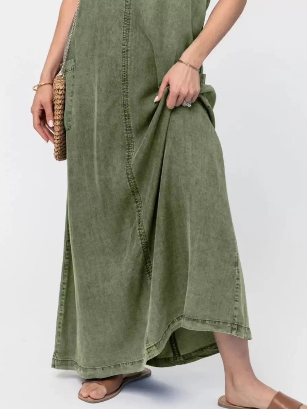 Moss denim maxi dress with pocket detail and seam accents.