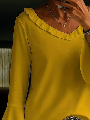 Ochre polyester blouse with V-neck, ruffled trim, and bell sleeves.