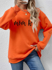 Orange graphic sweatshirt with black text that says Mom At, crewneck, long sleeves