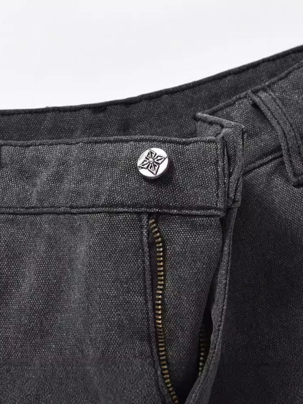 Dark carpenter jeans with embroidered star button detail and zipper.