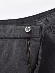 Dark carpenter jeans with embroidered star button detail and zipper.