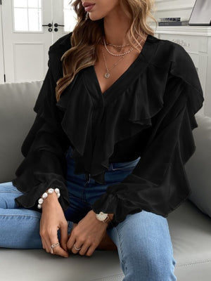 Black V-neck blouse with ruffled front and bell sleeves.