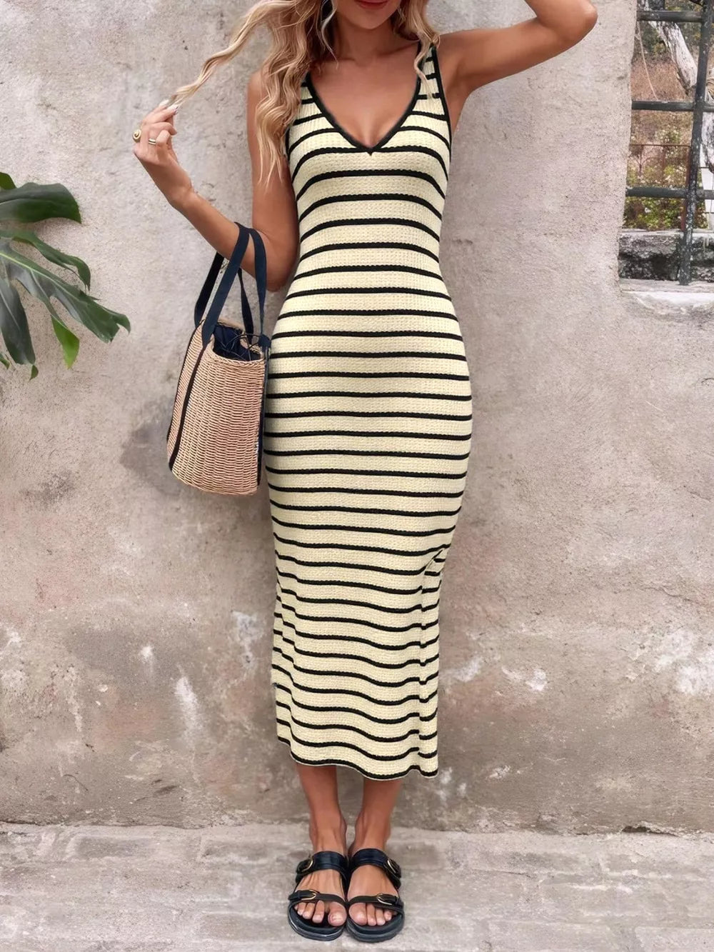 Ribbed striped bodycon midi dress in cream with black stripes, V-neck, sleeveless, and a fitted silhouette.