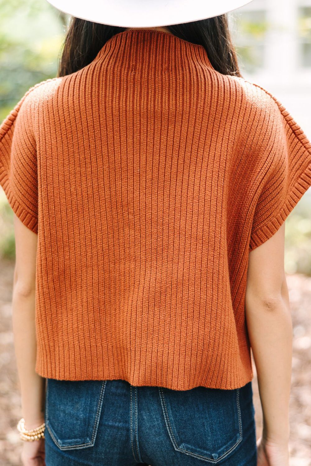 Caramel ribbed knit mock neck sleeveless top with short sleeves.