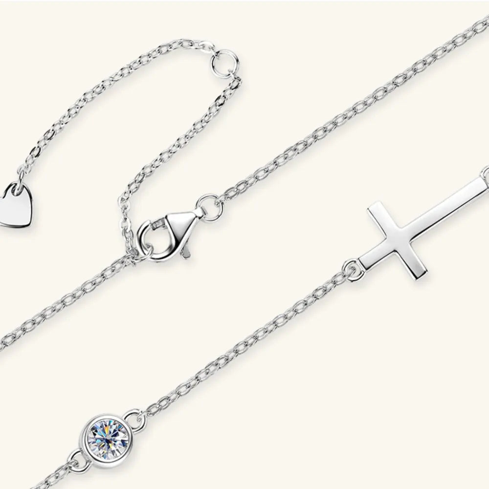 Silver asymmetrical cross pendant necklace with cubic zirconia and heart charm