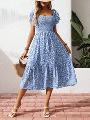 Blue floral smocked ruffle sleeve midi dress with tiered skirt and square neckline.