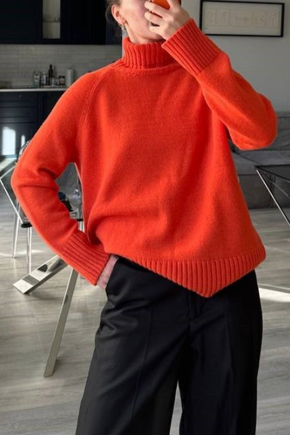 Orange cashmere turtleneck sweater with raglan sleeves and ribbed cuffs and hem.