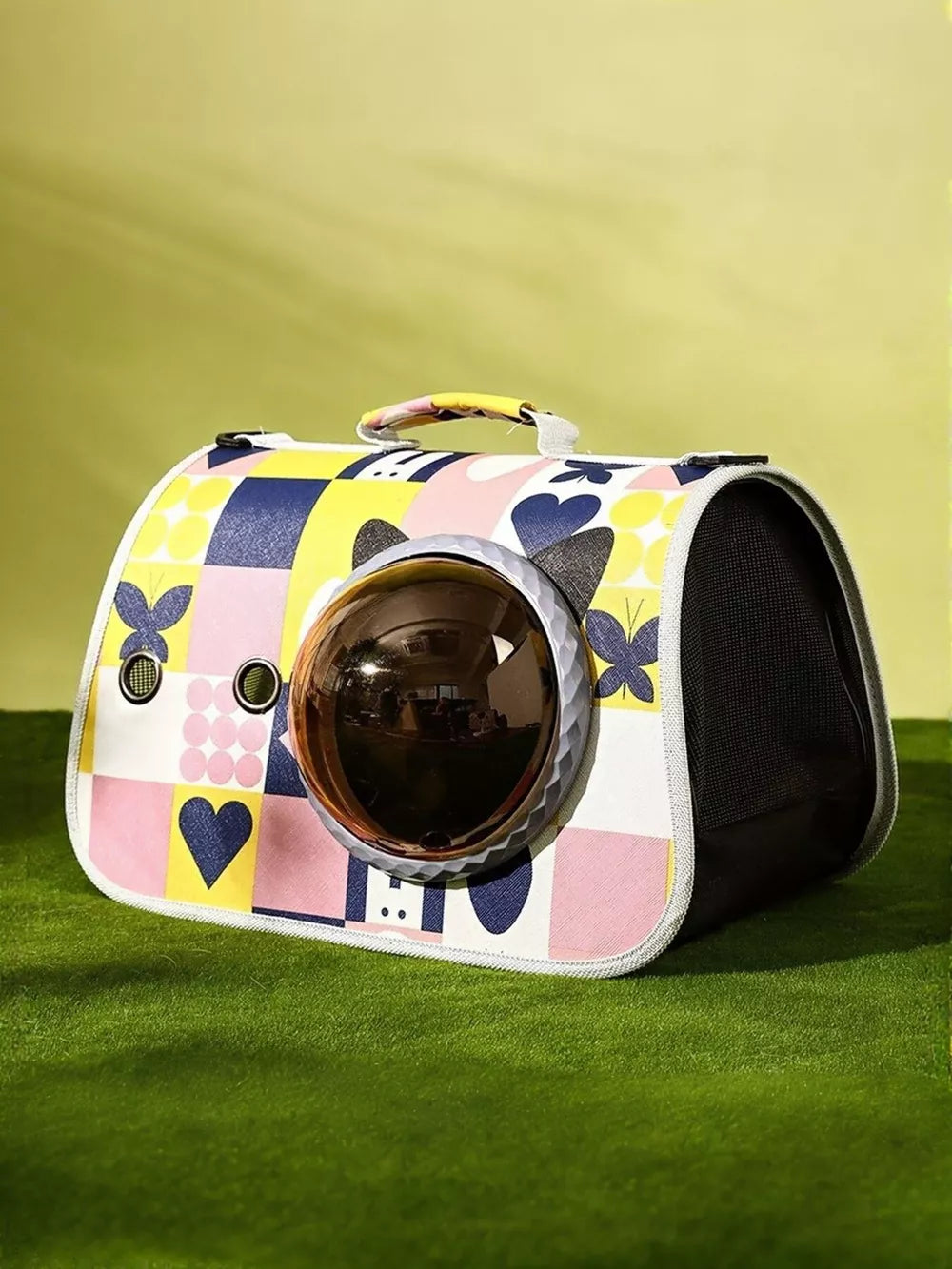 Charming bubble window pet carrier bag with colorful geometric and heart pattern.