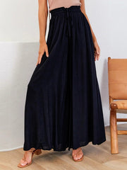 Black polyurethane palazzo pants with gathered waist and drawstring detail.