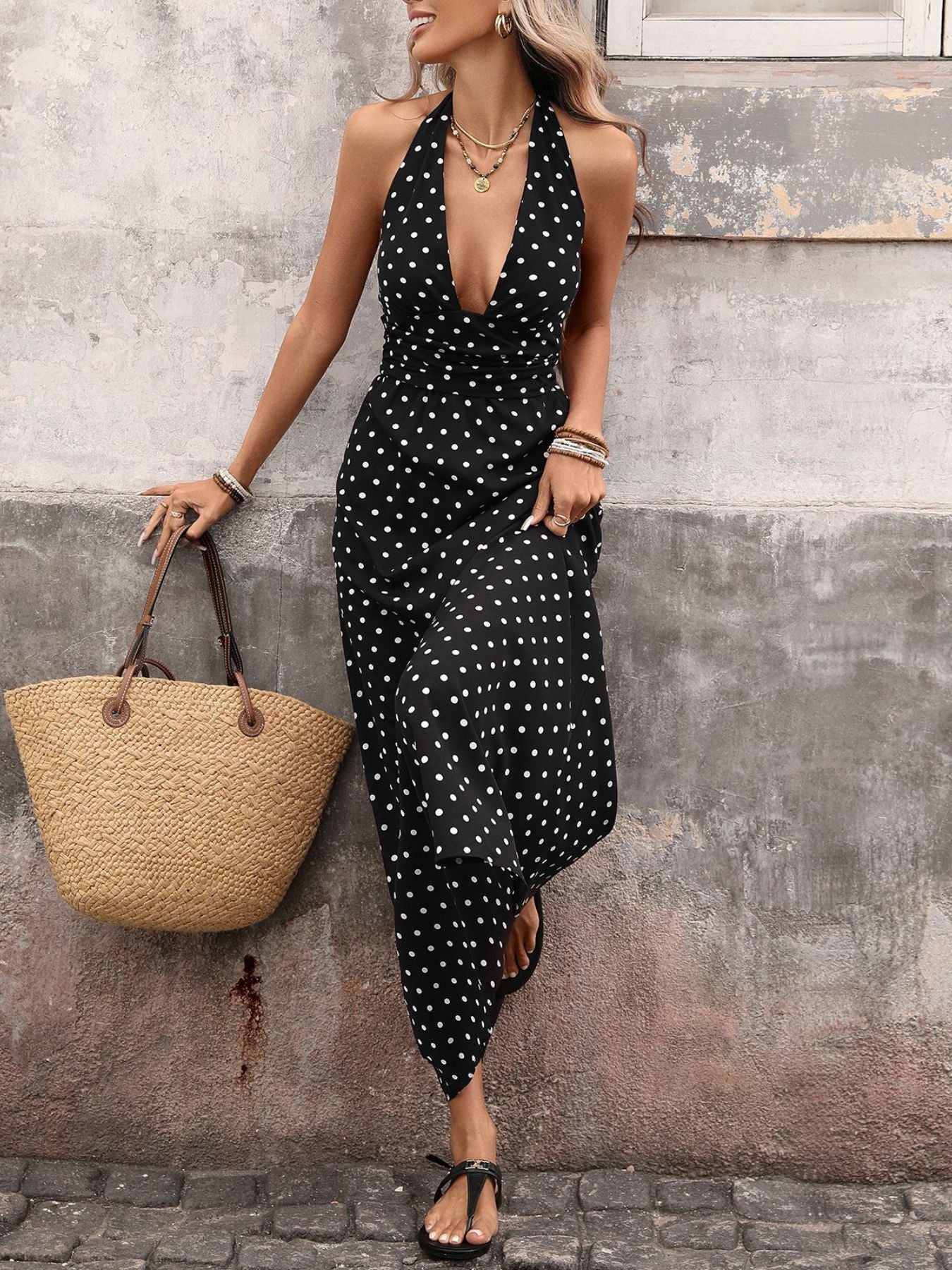 Black polka dot maxi dress with halter neck and deep V-neck