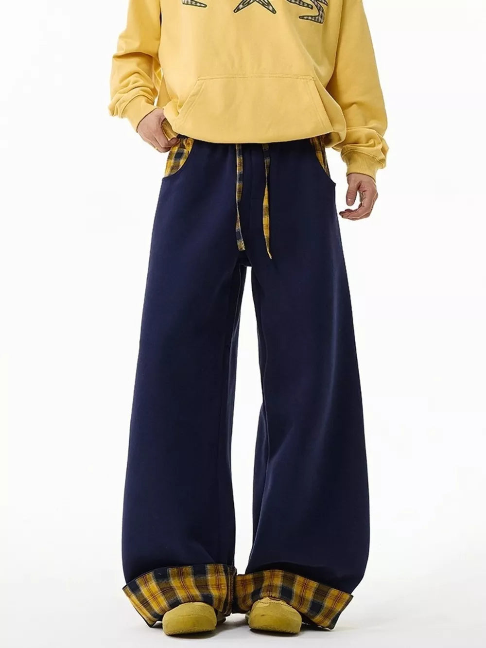 Navy blue wide-leg sweatpants with drawstring and plaid accents.