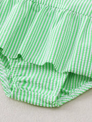Green striped seersucker one-piece swimsuit with ruffles and a bow detail.