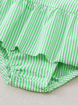 Green striped seersucker one-piece swimsuit with ruffles and a bow detail.