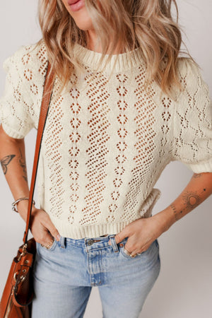 Cream lace-effect knit top with puff sleeves and diamond pattern detail.