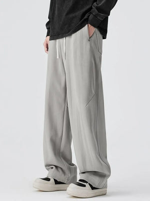 Light gray jogger pants with drawstring and relaxed fit.