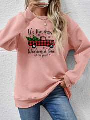 Blush pink sweatshirt with a graphic of a red buffalo plaid truck carrying Christmas trees and text.