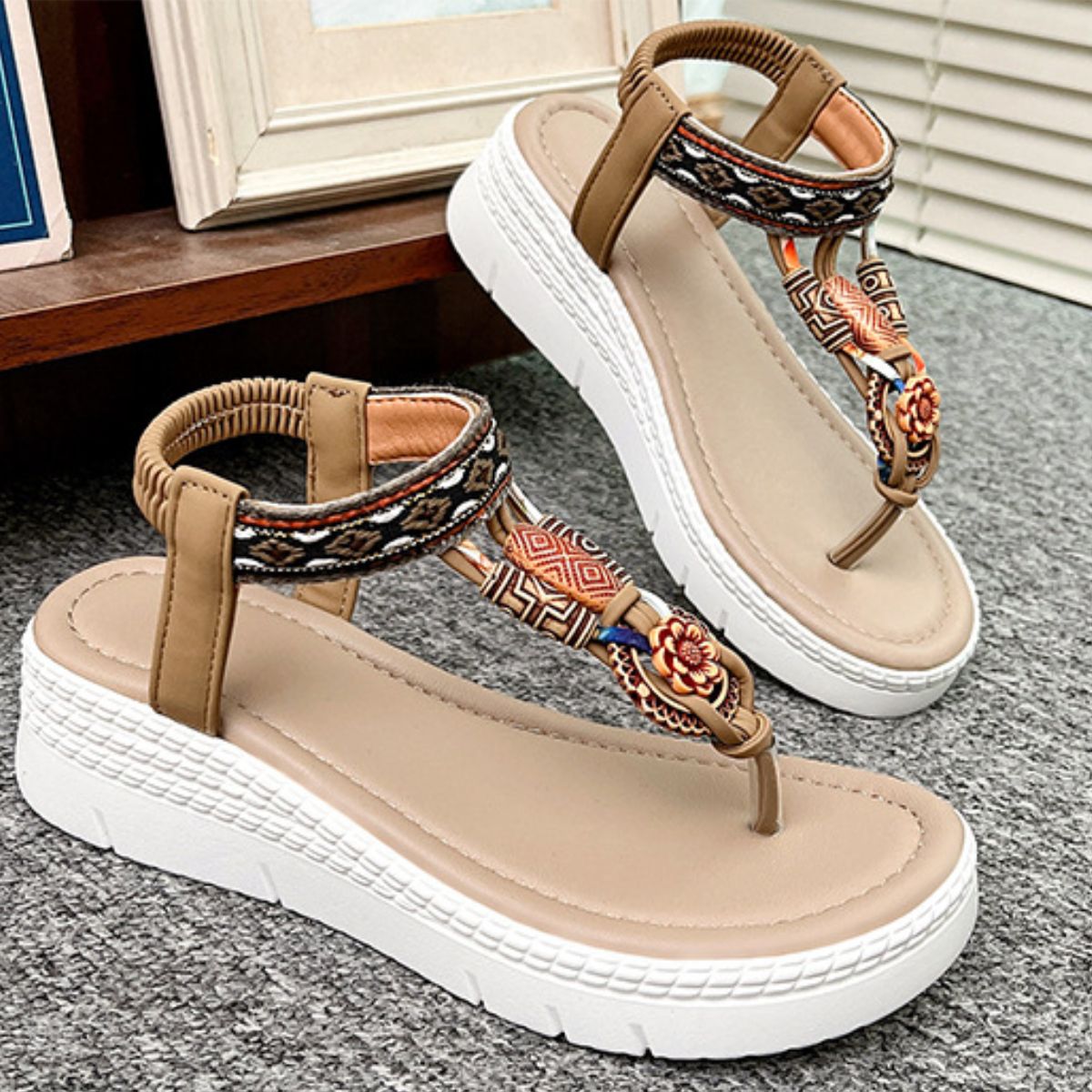 Ethnic patterned wedge sandals in khaki with floral accents and ankle straps.