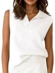 White sleeveless quarter-zip top and skort ensemble with a collared neckline.